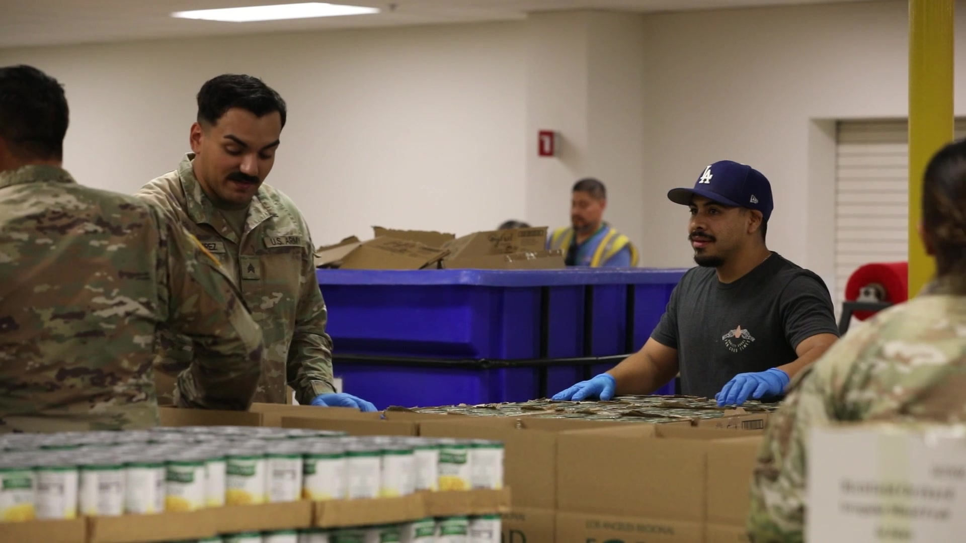 Food kit assembly with civilian and uniformed volunteers