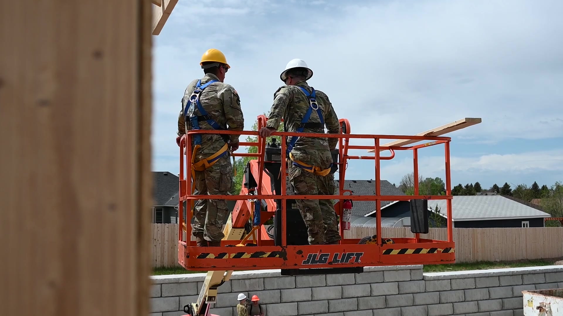 Workers and lumber in an elevated construction platform
