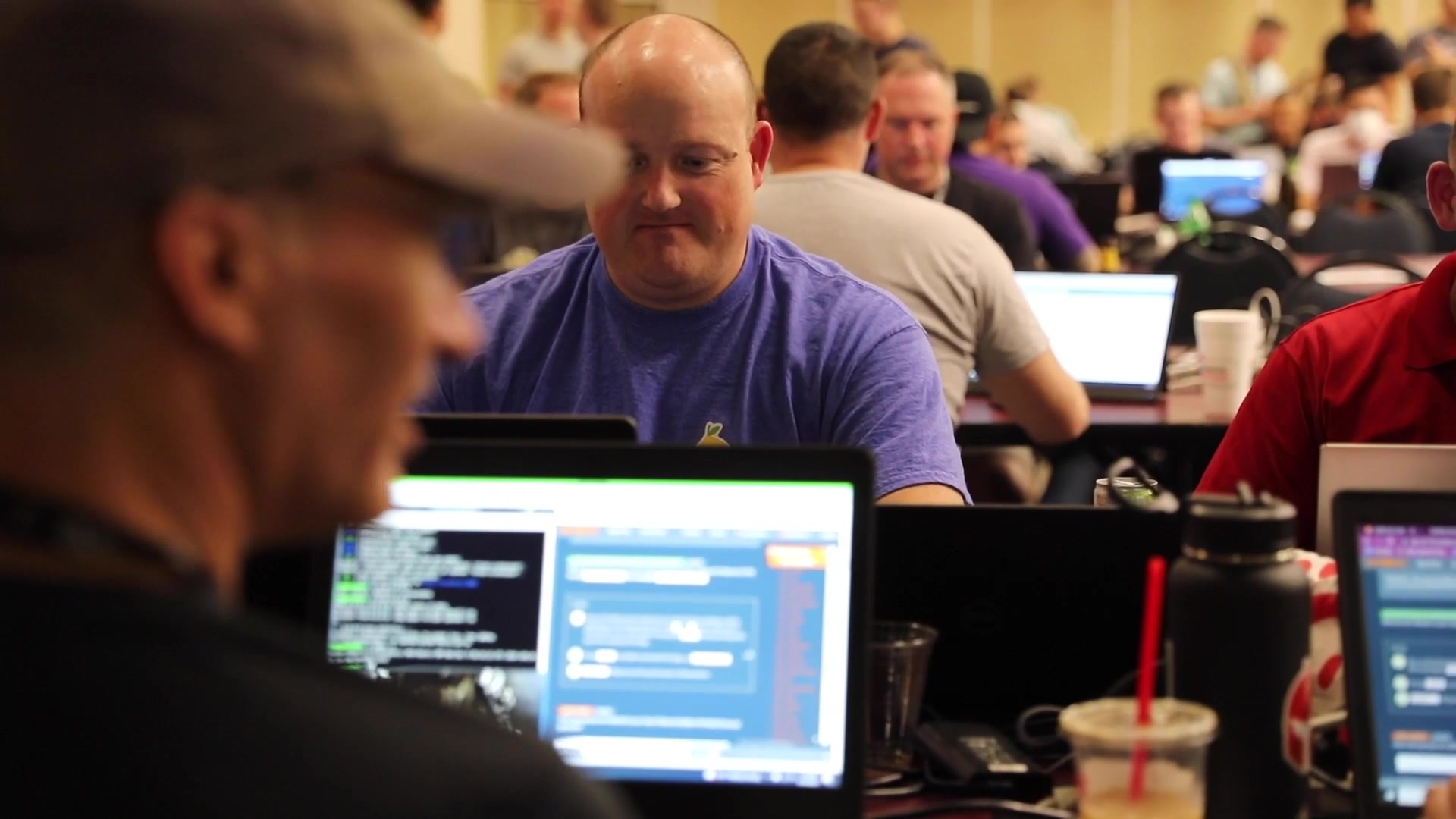 Participants discuss a task across computer workstations.